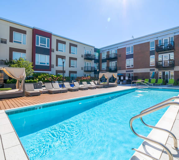 a swimming pool with an apartment building in the background at Park 205, Illinois, 60068