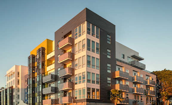 A modern multi-story building with a mix of residential and commercial spaces.