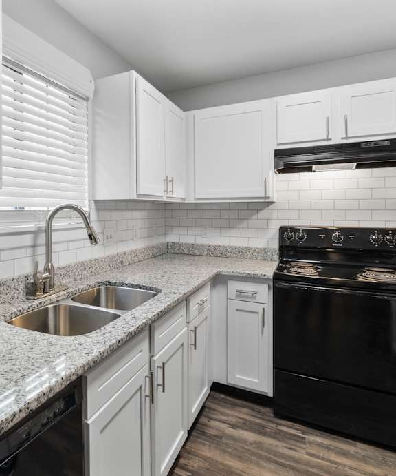 A kitchen with white cabinets and a black stove top oven.at Eagles Edge Apartments, Indianapolis, IN 462542