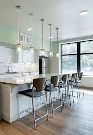 A modern kitchen with white cabinets and a large island.