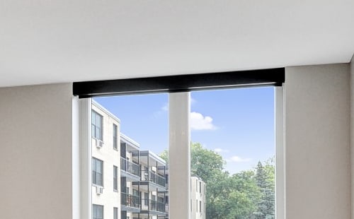 an empty living room with a large window