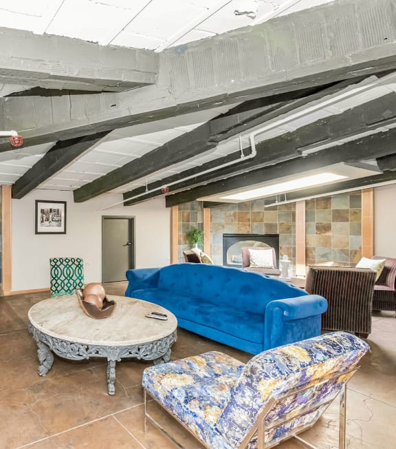 a living room with a blue couch and a table