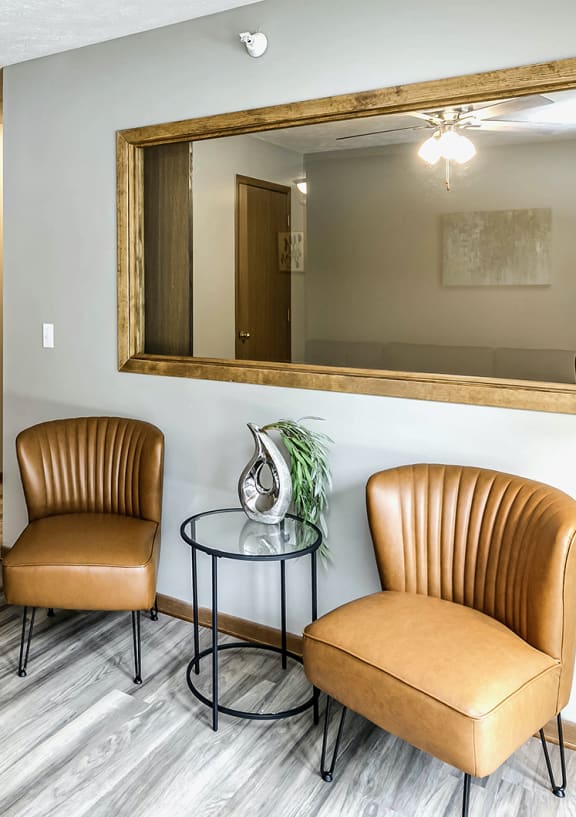 a living room with a table and two chairs
