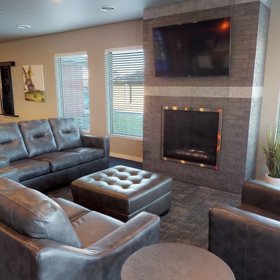 a living room with couches and a television and a pool table at Upscale Living at the Grand off 45th, Fargo, North Dakota