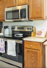 a kitchen with stainless steel appliances and wooden cabinets