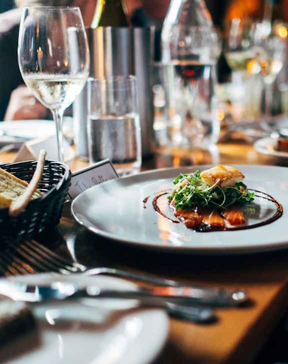 A person is holding a plate with food on it.