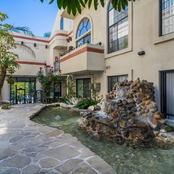 a house with a fountain in front of it