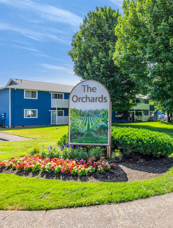 A blue building with a sign that says The Orchards.
