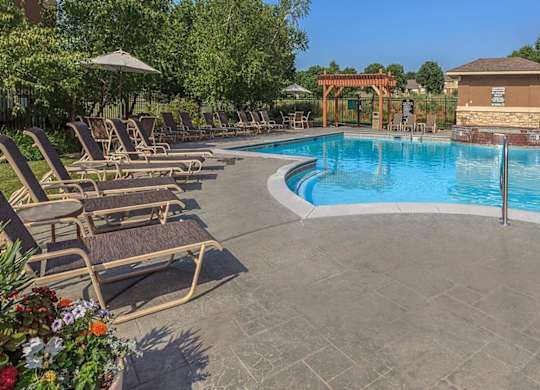 Lounge chair seating by an outdoor swimming pool at Stonepost Lakeside.