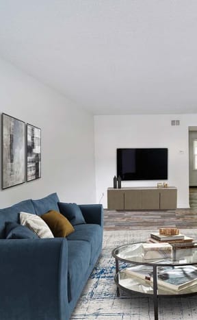 a living room with a blue couch and a television at Timberstone, Charlotte, 28217