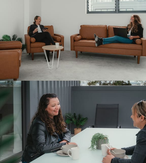 two women sitting on couches in an office