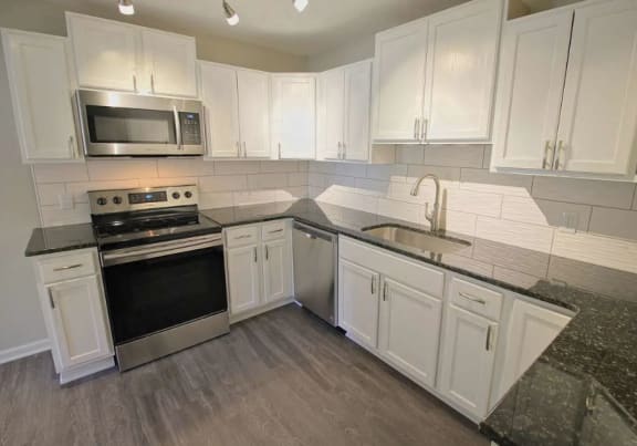 a living room and dining room with a couch and a table at Viceroy Apartments, North Carolina