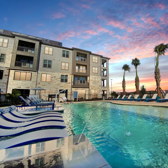 Cromwell at Plum Creek Apartments Pool Area and Lounge Chairs at Dusk