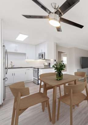 A modern kitchen with a dining table and chairs.