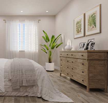 a bedroom with a large white bed and a plant
