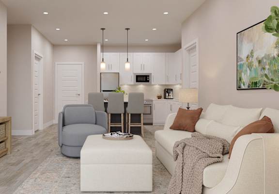 a living room with a couch and a chair and a kitchen