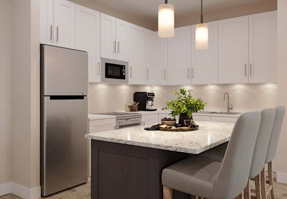 a kitchen with white cabinets and a marble counter top