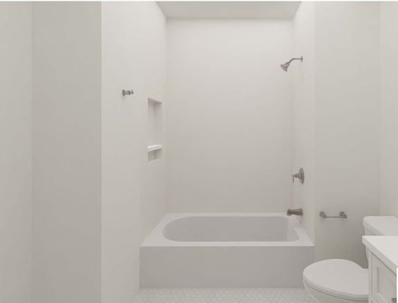 A white bathroom with a tub, toilet and sink.