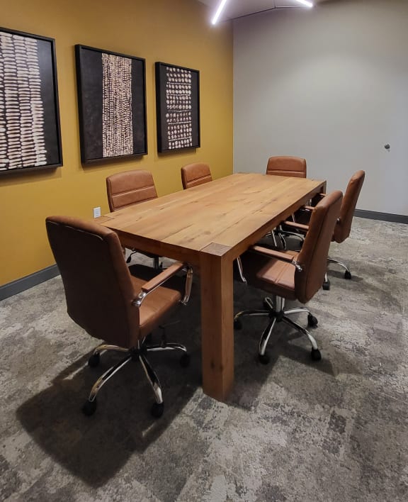 a conference room with a wooden table and chairs