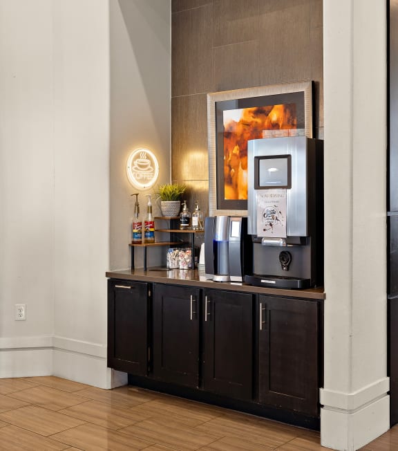 a lobby of a hotel with a coffee machine and a table with chairs at North Creek, Texas, 78634