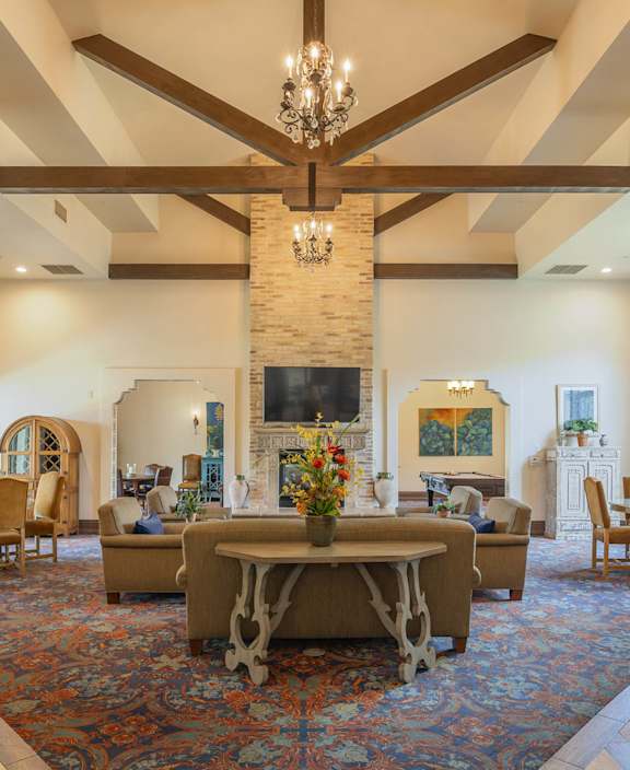 A large foyer with a staircase and a chandelier.