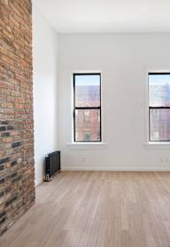 a pool table in a room with large windows
