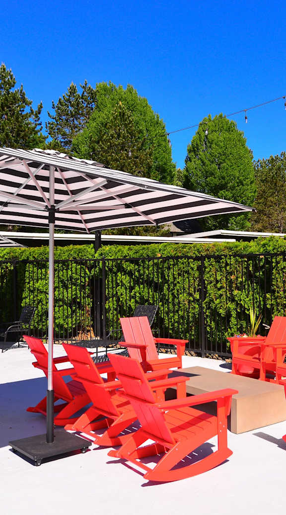 Outdoor seating with umbrella at Woodlake Apartments, Kirkland 98034