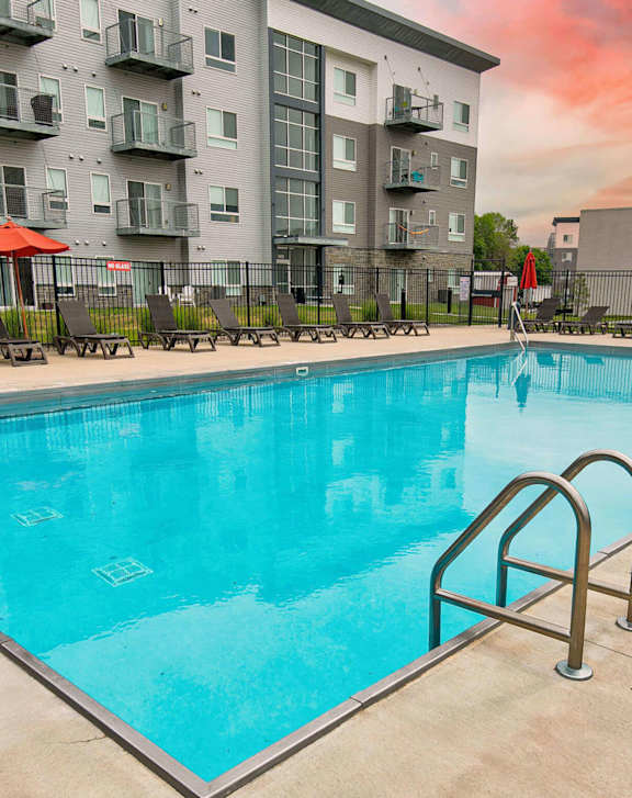 A swimming pool in front of a residential building. at Lake Shore Apartments, Ankeny, IA, 50021