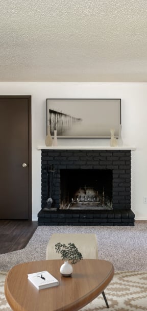 a living room with a fireplace and a couch and a coffee table