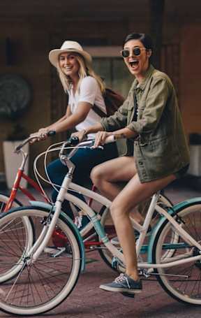 Friends Biking in Street  at The Aster Sugar Land Apartments, Sugar Land, Texas