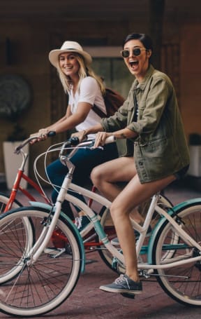 Friends Biking in Street  at The Aster Sugar Land Apartments, Sugar Land, Texas