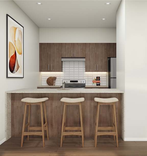 A kitchen with a bar area featuring a fridge, a toaster, and a coffee maker.