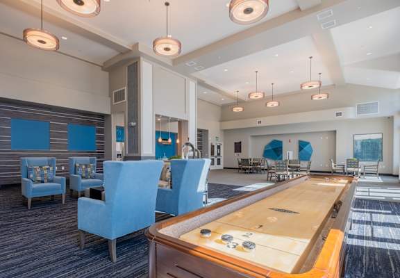 a recreation room with a foosball table and chairs