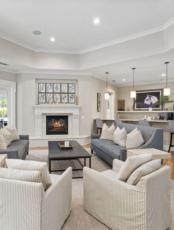 A living room with a grey couch and a fireplace.