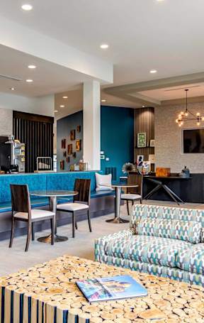 A living room with a blue couch and a coffee table.