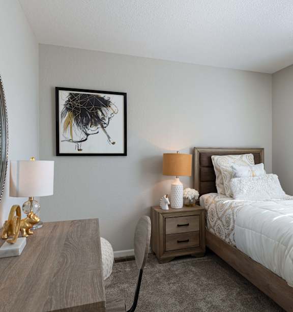 A living room with a grey couch and a wooden table.