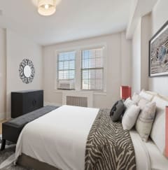a bedroom with a bed and a door to a hallway