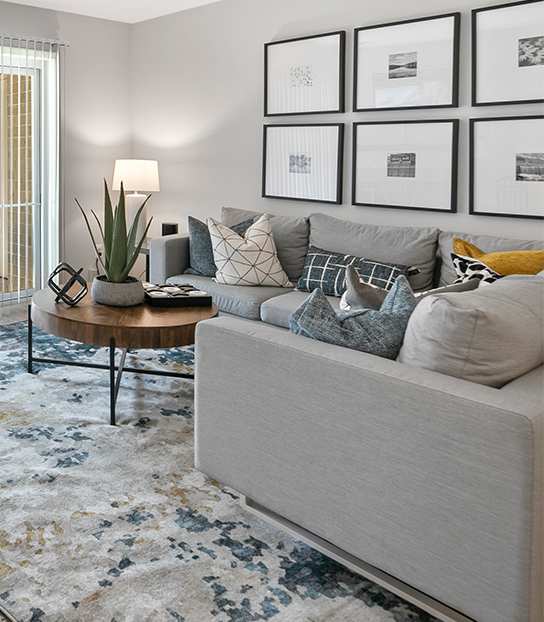 A modern living room with a blue couch and a coffee table.