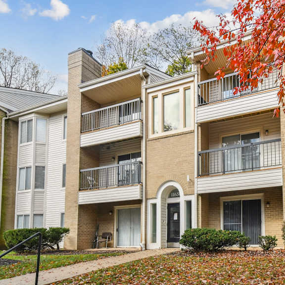 Apartment building with a sign in front of it.