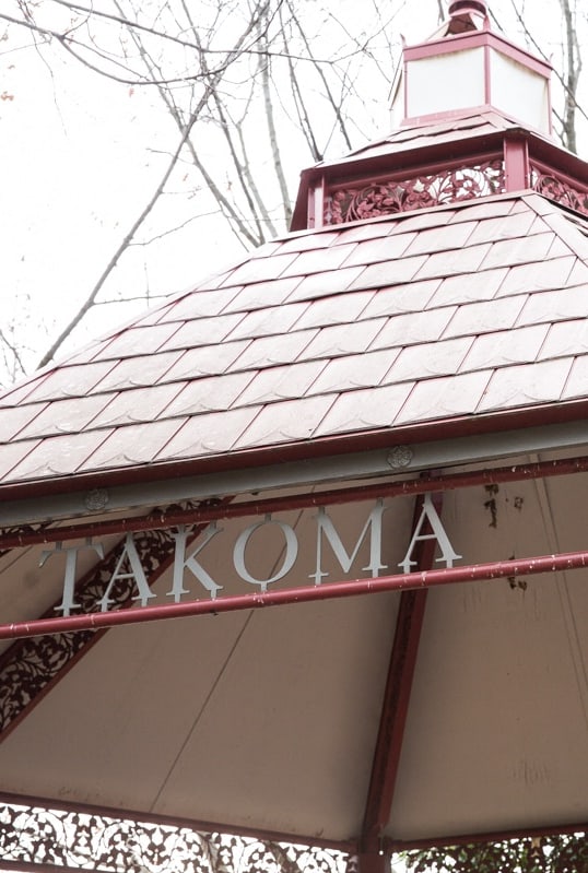 the facade of a restaurant with a mural on the side of the building