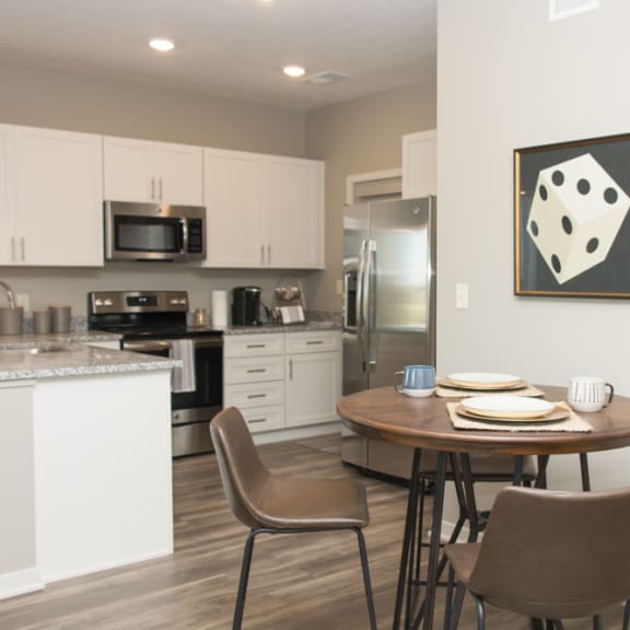 kitchen with white cabinets and dining area of to the side