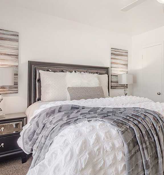 a bedroom with a bed and a ceiling fan