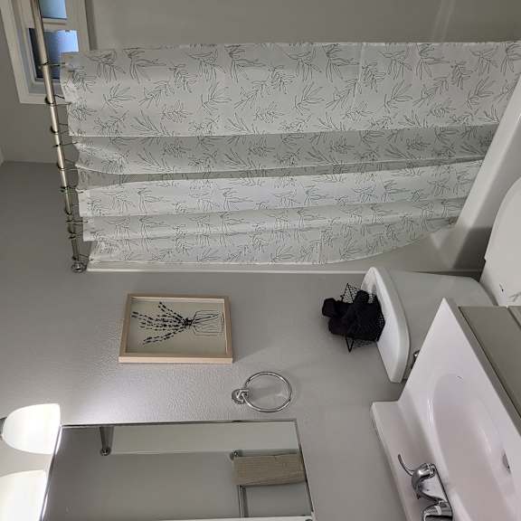 a small bathroom with a toilet and a sink and a shower