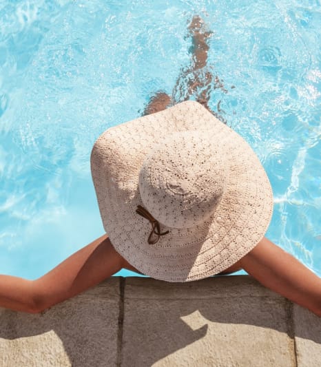 Woman in a floppy hat laying in a pool at South Pine, Union City, 30291