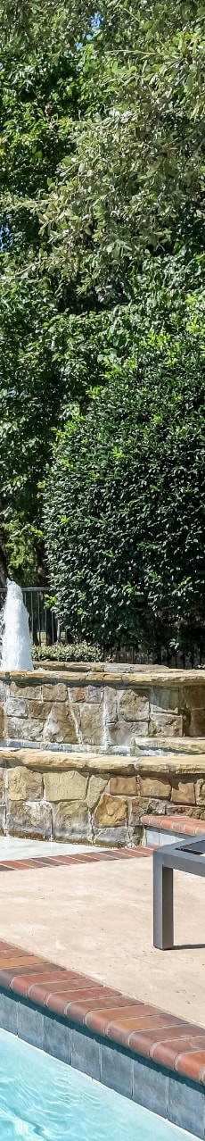 luxury swimming pool with a fountain at Stoneleigh on Spring Creek apartments