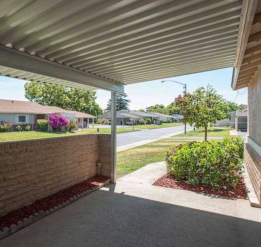 a covered porch with a view of a street and some houses at Castle Vista Senior Duplex Community, Atwater, CA, 95301