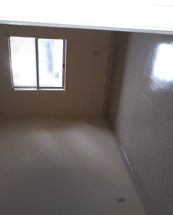 an empty room in a house with a window