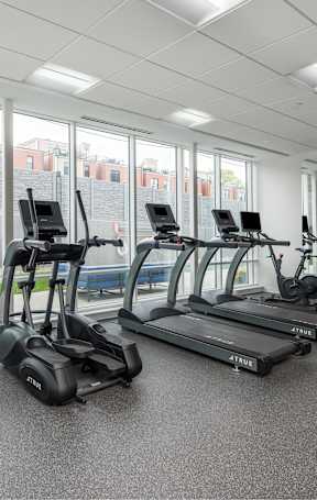a large fitness room with cardio equipment and weights at 2200 LaSalle, Missouri, 63104