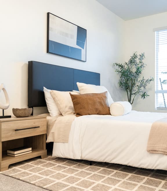 Bed in Main Bedroom at The Arza Apartments in American Fork, UT