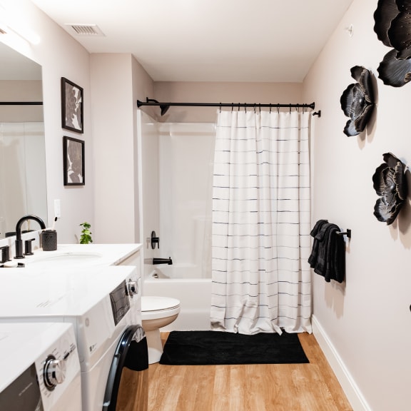 a laundry room with white cabinets and a white washer and dryer
